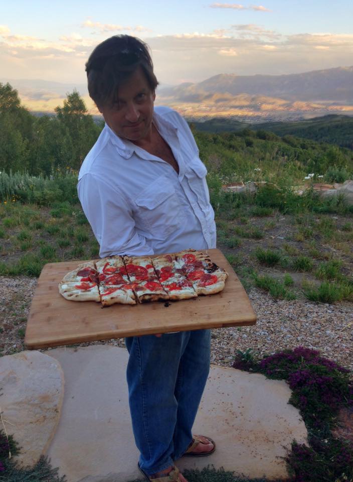 man holding fresh pizza