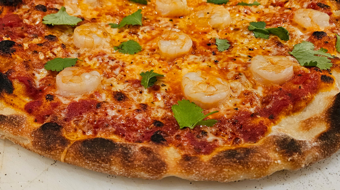 shrimp and garlic pizza with cilantro garnish